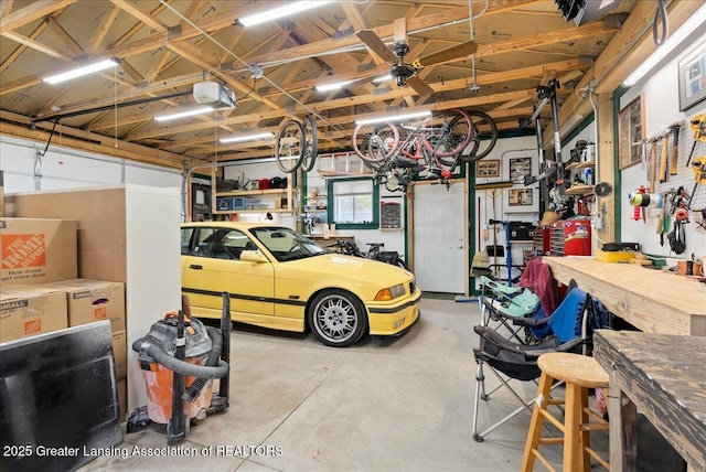 garage featuring a workshop area and a garage door opener