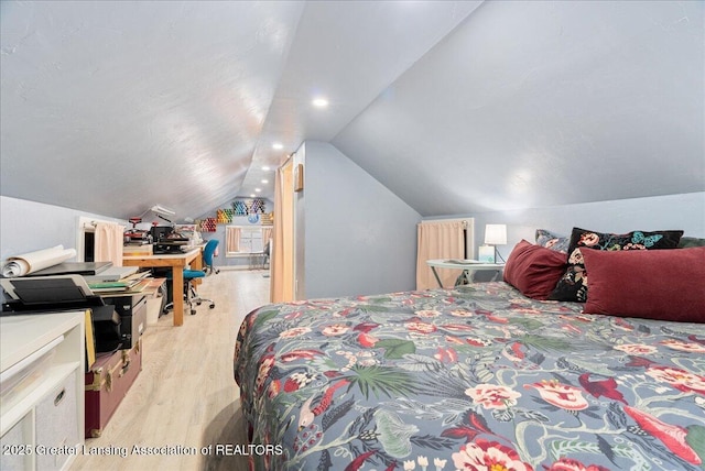 bedroom with recessed lighting, vaulted ceiling, and light wood-type flooring