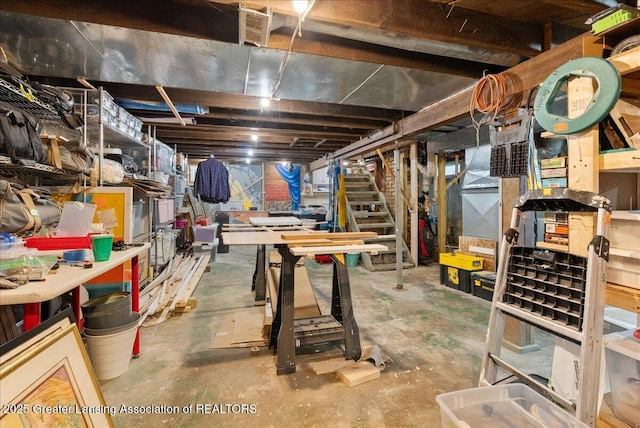unfinished below grade area with stairs and a workshop area