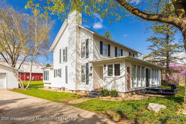 1061 E Sherwood Rd, Williamston, MI 48895 - view of front of house with a chimney, a front lawn, and entry steps
