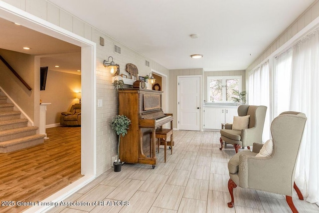 1061 E Sherwood Rd, Williamston, MI 48895 - sitting room with stairway and light wood-style flooring