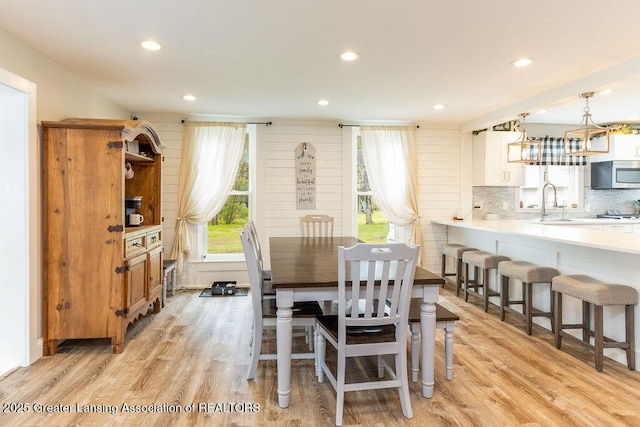 1061 E Sherwood Rd, Williamston, MI 48895 - dining area featuring light wood finished floors, recessed lighting, and a chandelier