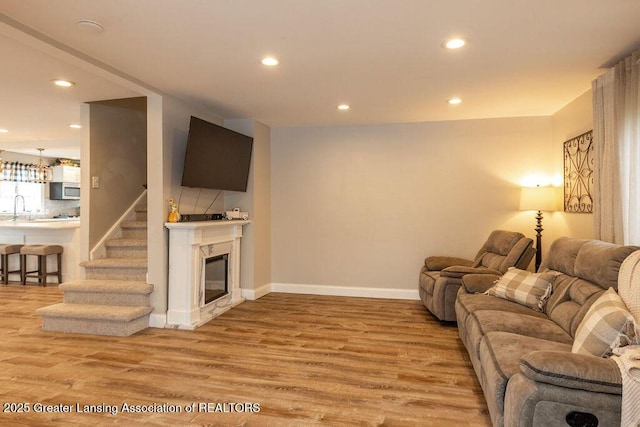 1061 E Sherwood Rd, Williamston, MI 48895 - living room with light wood finished floors, recessed lighting, baseboards, and a fireplace