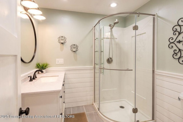 1061 E Sherwood Rd, Williamston, MI 48895 - full bathroom with a stall shower, vanity, a wainscoted wall, and recessed lighting