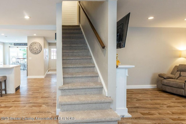 1061 E Sherwood Rd, Williamston, MI 48895 - stairway featuring wood finished floors, baseboards, and recessed lighting