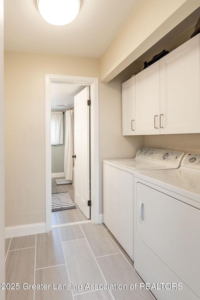 1061 E Sherwood Rd, Williamston, MI 48895 - laundry area with separate washer and dryer, cabinet space, and baseboards