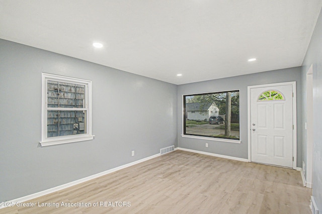 spare room with visible vents, recessed lighting, baseboards, and wood finished floors