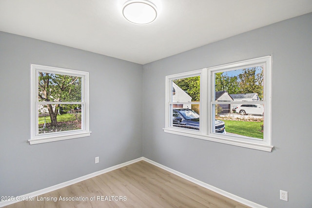 empty room with light wood-style floors and baseboards