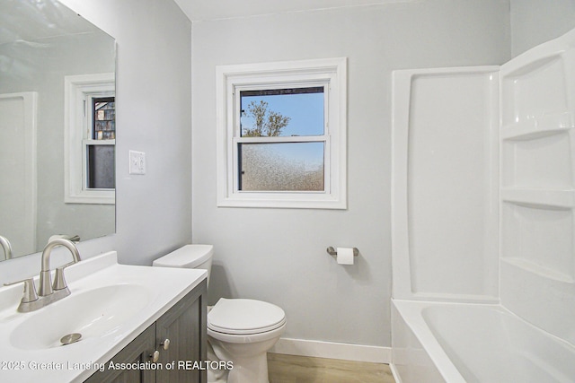full bathroom with baseboards, vanity, toilet, and wood finished floors