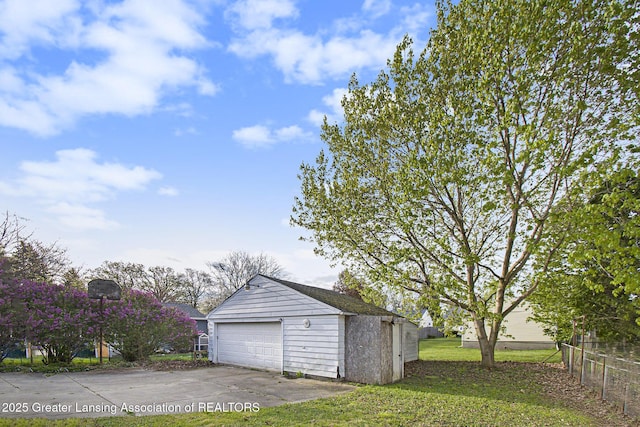 detached garage featuring fence