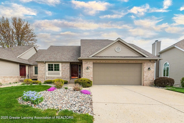 6032 Vienna Way, Lansing, MI 48917 - traditional home with concrete driveway, brick siding, a shingled roof, and a garage