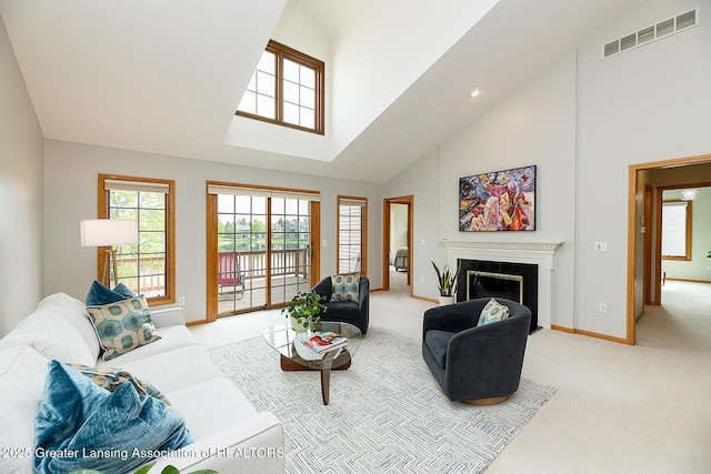 6032 Vienna Way, Lansing, MI 48917 - living area with visible vents, a fireplace with flush hearth, high vaulted ceiling, baseboards, and light carpet
