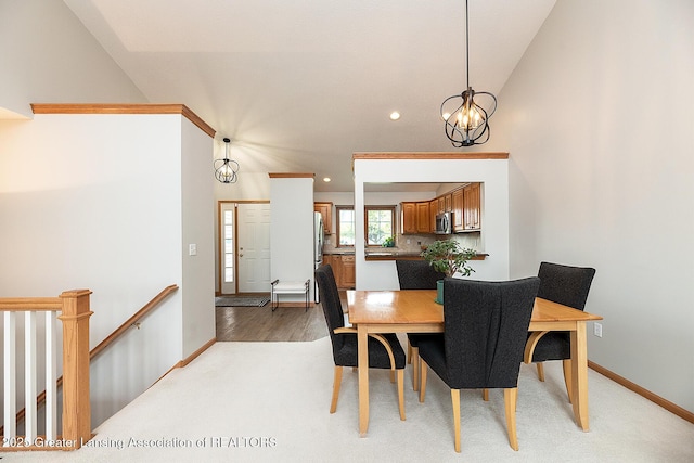 6032 Vienna Way, Lansing, MI 48917 - dining room with recessed lighting, baseboards, a notable chandelier, and light wood-type flooring