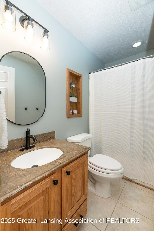 6032 Vienna Way, Lansing, MI 48917 - bathroom featuring vanity, tile patterned flooring, toilet, and curtained shower