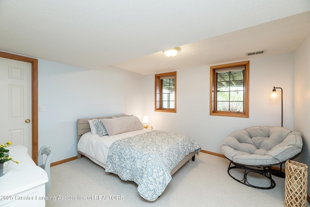 6032 Vienna Way, Lansing, MI 48917 - bedroom featuring visible vents, baseboards, and light carpet