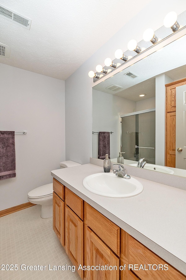 6032 Vienna Way, Lansing, MI 48917 - full bathroom with visible vents, a stall shower, toilet, and vanity