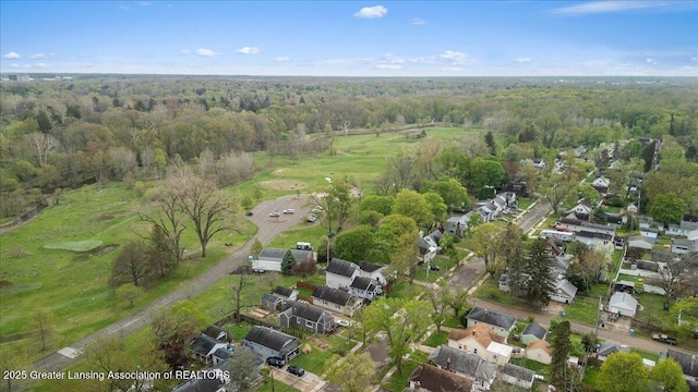 drone / aerial view featuring a forest view and a residential view