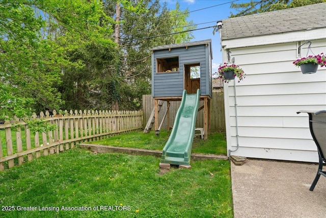 view of play area featuring a yard and fence
