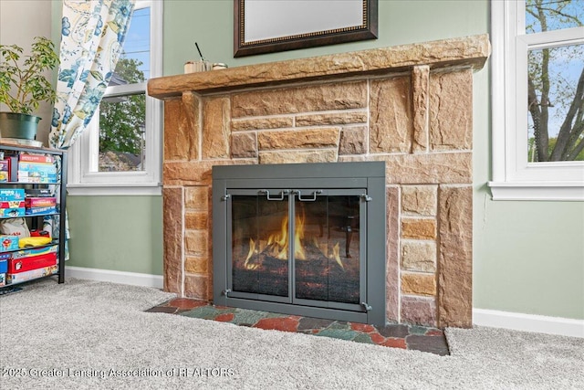 room details with carpet, baseboards, and a fireplace