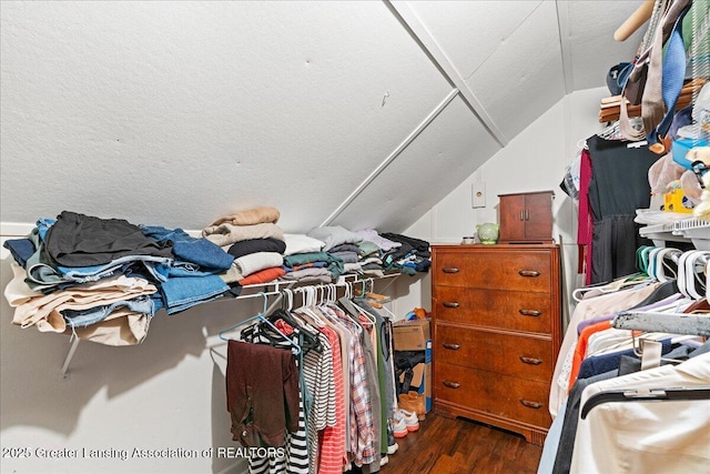 walk in closet featuring wood finished floors and vaulted ceiling