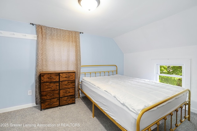 bedroom featuring carpet flooring, baseboards, and lofted ceiling