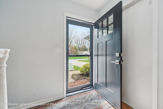 1212 Sandhill Dr, Dewitt, MI 48820 - doorway with baseboards and wood finished floors