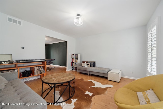 1212 Sandhill Dr, Dewitt, MI 48820 - living area featuring visible vents, wood finished floors, and baseboards
