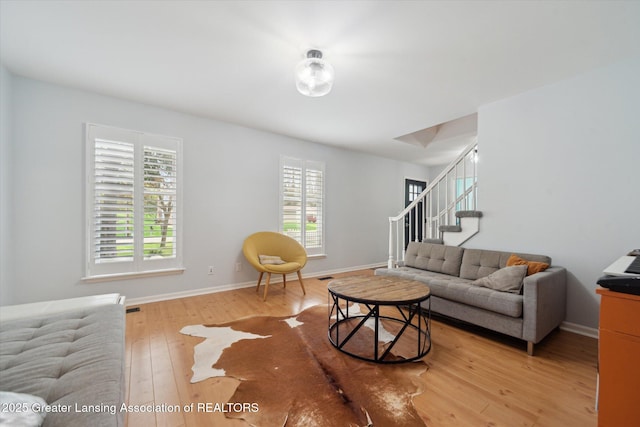 1212 Sandhill Dr, Dewitt, MI 48820 - living room featuring stairway, wood-type flooring, and baseboards