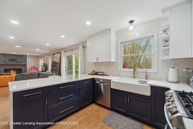 1212 Sandhill Dr, Dewitt, MI 48820 - kitchen with white cabinets, a peninsula, a sink, and dishwasher