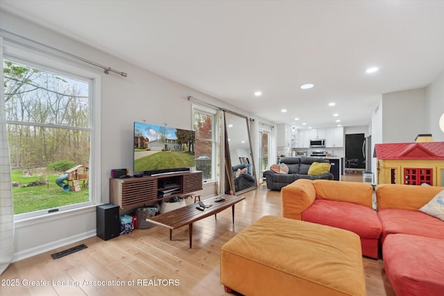 1212 Sandhill Dr, Dewitt, MI 48820 - living room with light wood-type flooring, visible vents, baseboards, and recessed lighting
