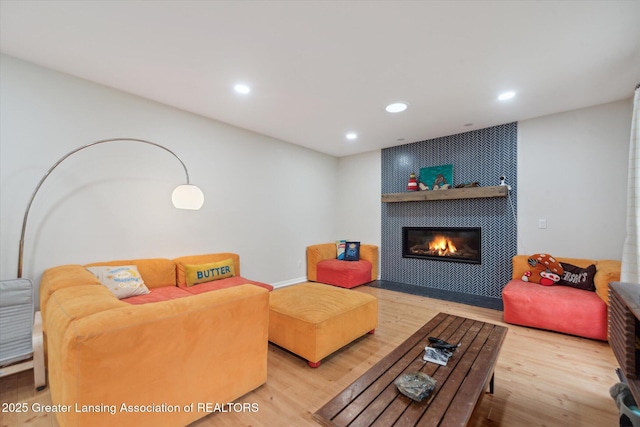 1212 Sandhill Dr, Dewitt, MI 48820 - living room featuring a tile fireplace, recessed lighting, and wood finished floors