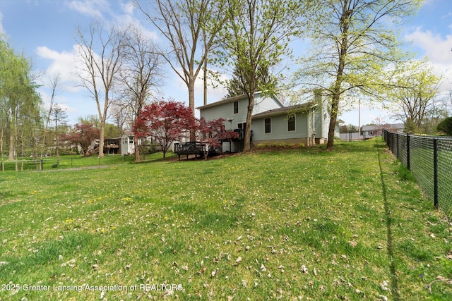 1212 Sandhill Dr, Dewitt, MI 48820 - view of yard featuring a deck and fence