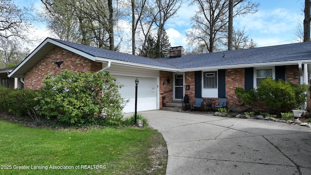 ranch-style house with a chimney, driveway, brick siding, a garage, and roof with shingles