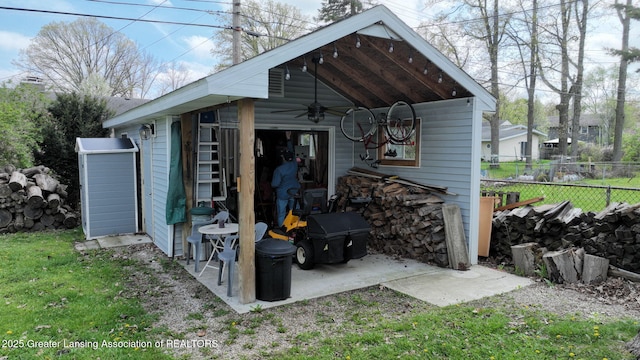 view of outbuilding featuring fence