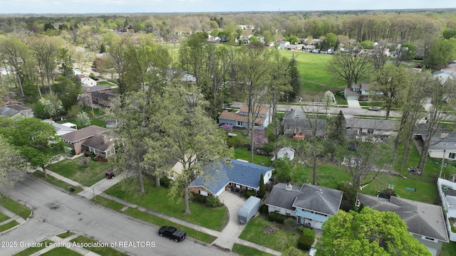 drone / aerial view featuring a forest view and a residential view