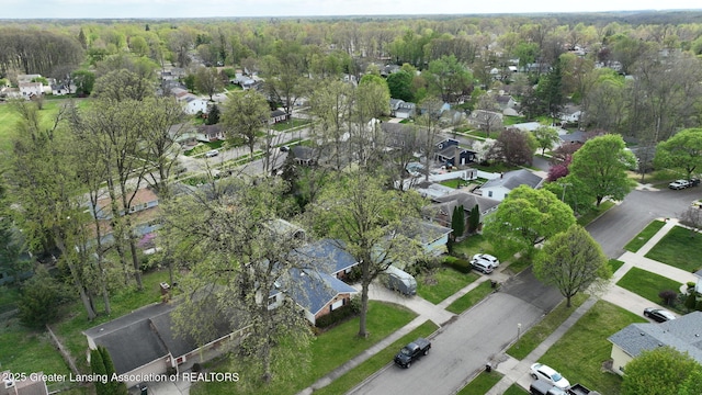 drone / aerial view with a residential view and a view of trees