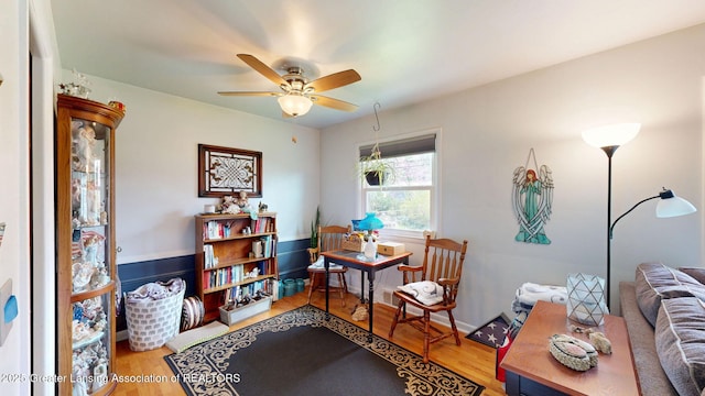 sitting room featuring ceiling fan and wood finished floors