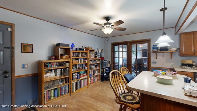 dining space with light wood finished floors, french doors, and ceiling fan