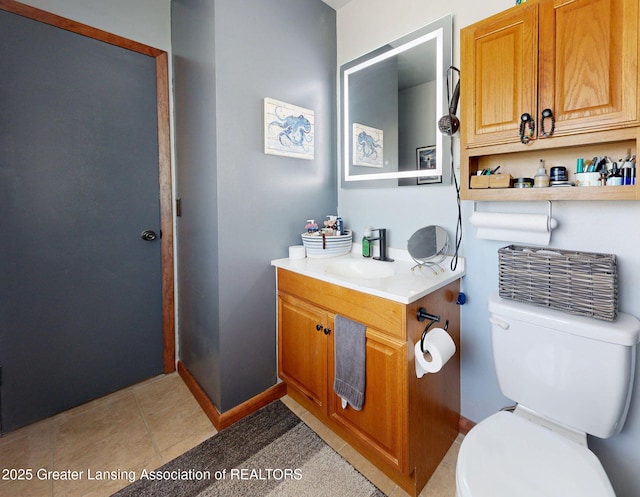 bathroom featuring toilet, baseboards, tile patterned flooring, and vanity