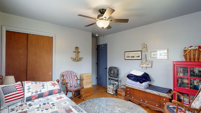 bedroom featuring a closet, wood finished floors, and ceiling fan