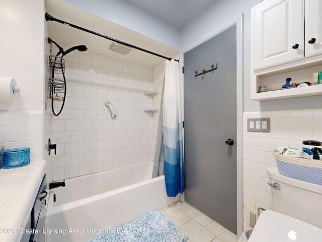 full bath with toilet, tile walls, tile patterned floors, and shower / bath combo