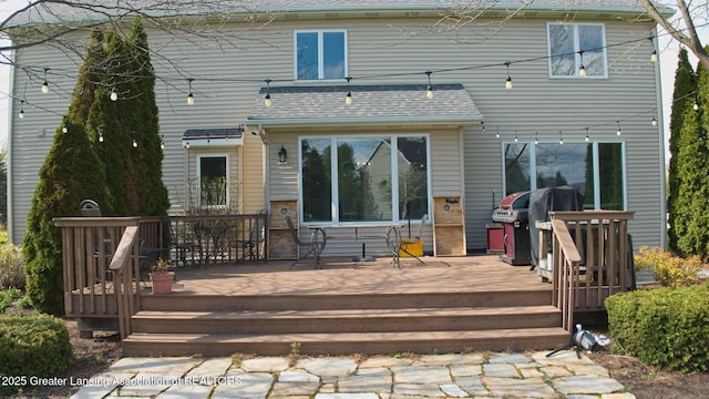 rear view of house with a wooden deck