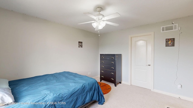 bedroom with light colored carpet, baseboards, ceiling fan, and visible vents