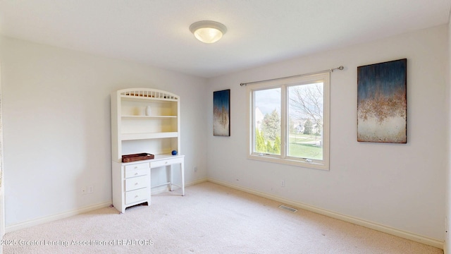 unfurnished bedroom featuring light carpet, baseboards, and visible vents