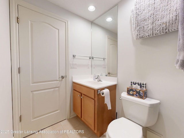half bathroom featuring toilet, tile patterned floors, vanity, and recessed lighting