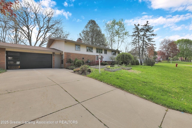single story home featuring a chimney, driveway, brick siding, a garage, and a front yard