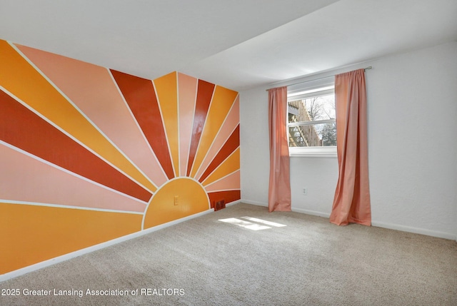 carpeted spare room with baseboards