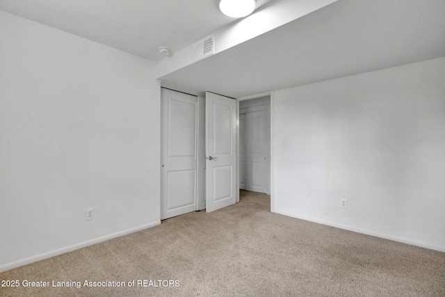 unfurnished bedroom featuring a closet, visible vents, baseboards, and carpet floors