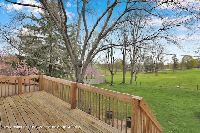 deck featuring a yard and fence