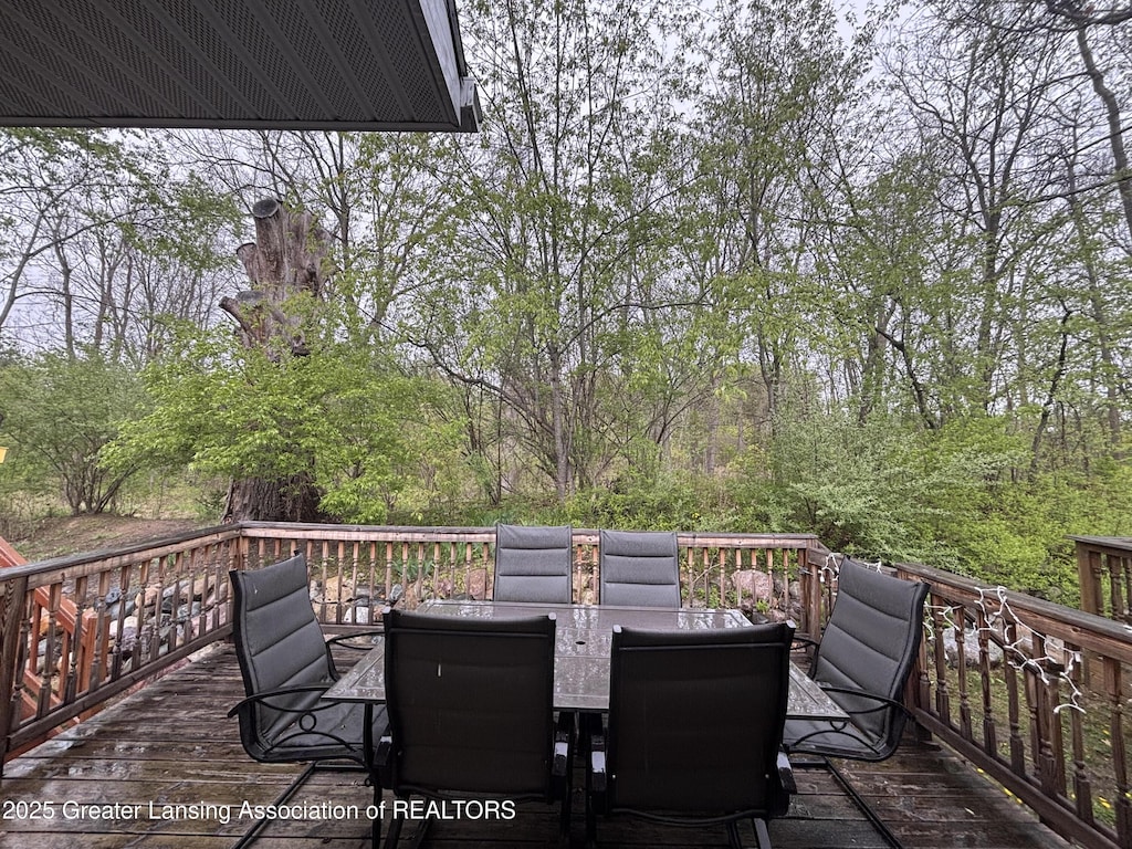 wooden terrace with outdoor dining space